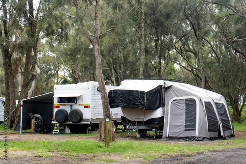 Various RV caravan camper on a campsite at the holiday caravan park surrounding by nature