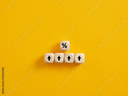 Percent and upwards increasing arrows on wooden cubes. Financial interest mortgage rates increase or price commission raise