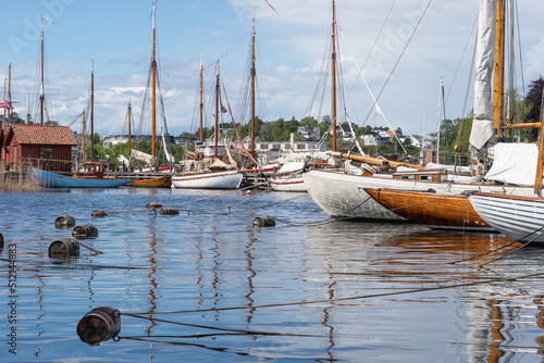 Wooden sailboats reflected on the water in Fredrikstad, Norway.