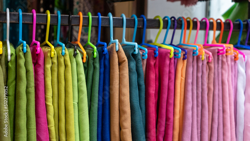Colorful cloth display. Colorful hangers. Fabrics of various colors.