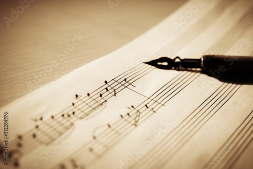 Music sheet, sheet music and feather, concept of composing music, music background