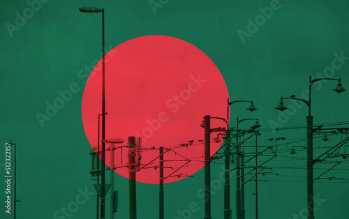 Bangladesh flag with tram connecting on electric line with blue sky as background, electric railway train and power supply lines, cables connections and metal pole overhead catenary wire