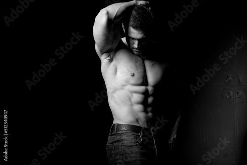 Muscular and sexy torso of young man having perfect abs, bicep and chest. Male hunk with athletic body. Fitness concept.