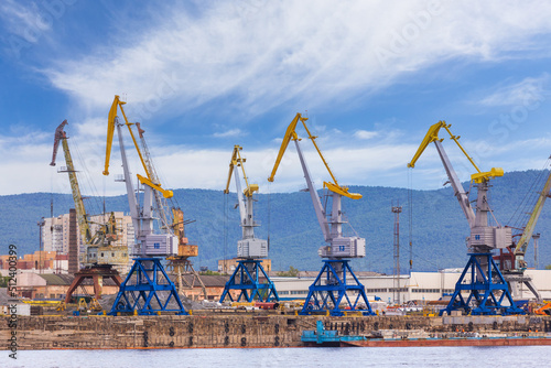 Cargo cranes in the river port in Yenisey river in Krasnoyarsk, Russia