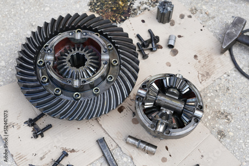 Close up on disassembling differential vehicle part during repair gear axle assembly