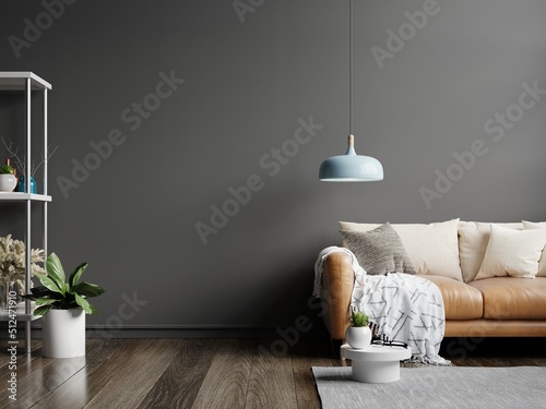 Interior wall mockup in dark tones with leather sofa on black wall background.