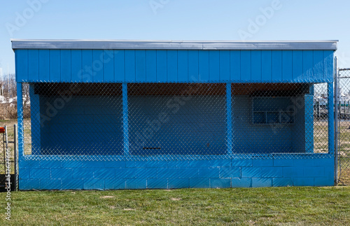 Rural community wooden baseball dugout. Simple sparse.