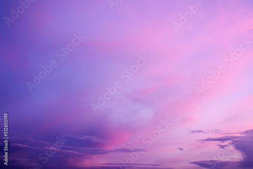 Purple sky background with clouds at sunset on a summer evening 