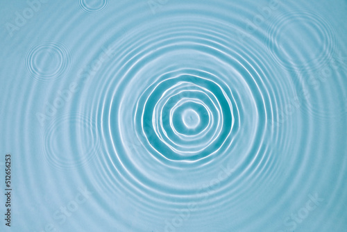 Blue water texture, surface with rings and ripples. Spa concept background. Flat lay, copy space.