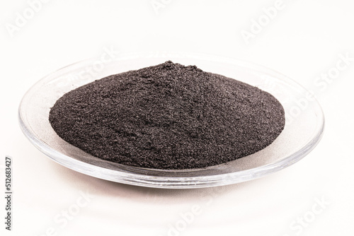 Cobalt powder coarse mesh 99.9 high flow cobalt metal on white isolated background, industrial use black powder