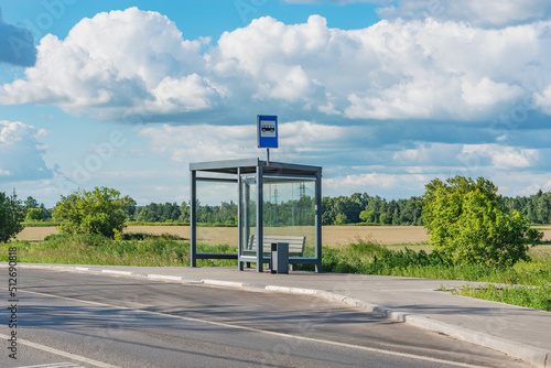 Empty bus stop by the field.