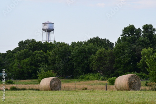 Hay Bales in a Farm Field with a Water Tower in the Background