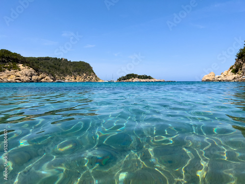 Inside a crystal clear water in famous Ibiza beach called Port San Miguel. mediterranean paradise vacations. 