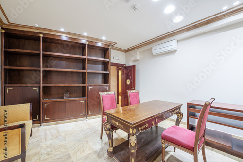 Professional office with vintage wooden furniture with table, chairs, chaise lounge and sideboards