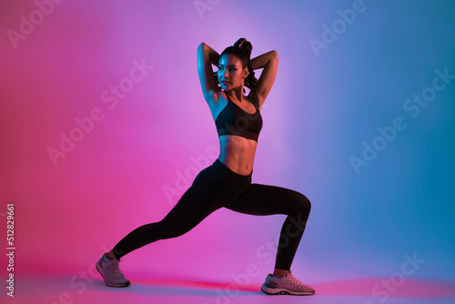 Young beautiful Asian woman in sports outfits doing stretching before workout in fitness. Healthy young woman warming up.