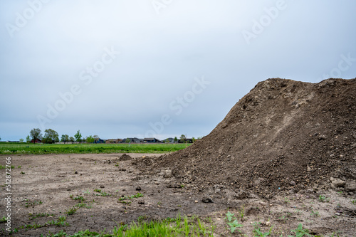 stockpiled topsoil at a residential development construction site.