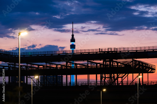 Panorama of Dortmund Germany with TV-Tower and steel construction. after colorful Sunset summer. Blue hour twilight with silhouettes of pipes, tubes and framework of historic blast furnace factory.