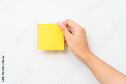 Women hand hold yellow adhesive note