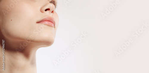 Flyer. Closeup female lips, cheeks and nose isolated over white studio background. Concept of cosmetology, skincare, cosmetics, plastic surgery, ad