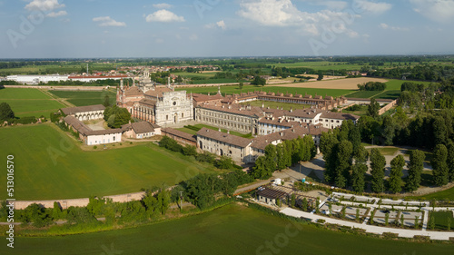 Aerial shot of the Certosa di Pavia at sunny day, built in the late fourteenth century, courts and the cloister of the monastery and shrine in the province of Pavia, Lombardia, Italy