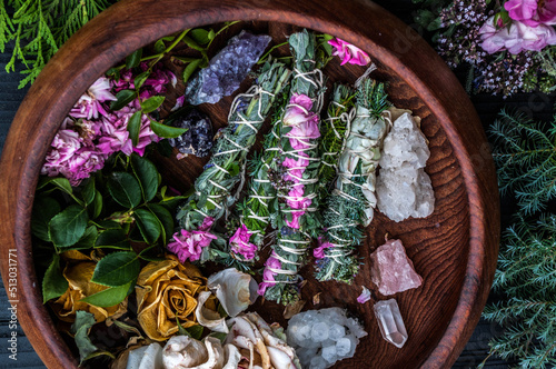 Smudge sticks and crystals on a black wooden table