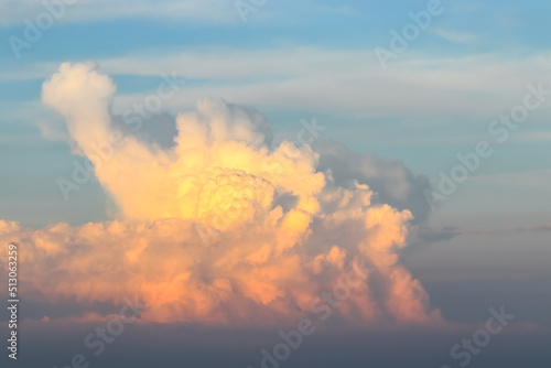 Large orange cumulonimbus cloud in the evening at sunset