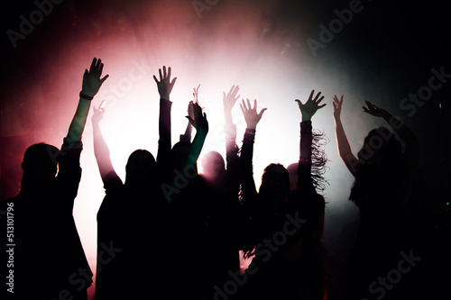 Silhouettes of young people dancing in club. Disco and party concept