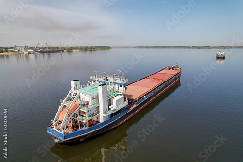 Cargo transportation. Cargo ship on the Volga River in front of the port with grain. Volgograd. Russia