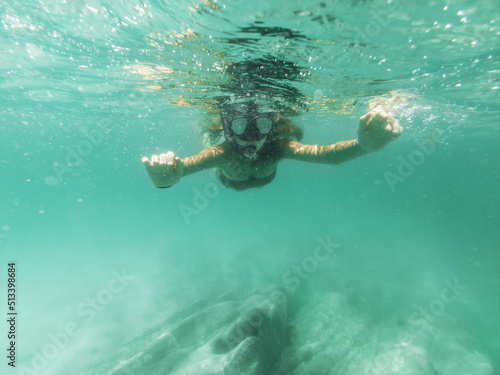 Girl Exploring Seafloor During Scuba Diving In The Sea