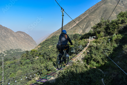 Aerial extreme sport, EXTREME FLYING BIKE, tourist attraction in San Mateo de Otao - Peru.