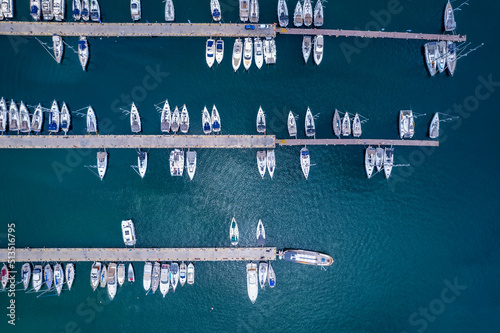 Aerial topdown view to a marina with moored luxury yachts and sailing boats in Greece