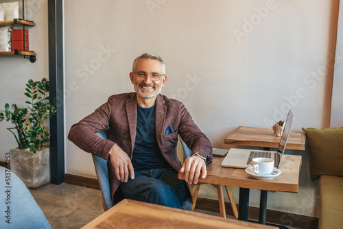 Man sitting at table smiling at camera