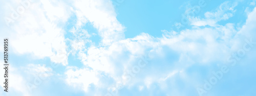 Cloudy and bright shinny blue sky background with white clouds, fluffy and blurry summer sky background for wallpaper and design related works.