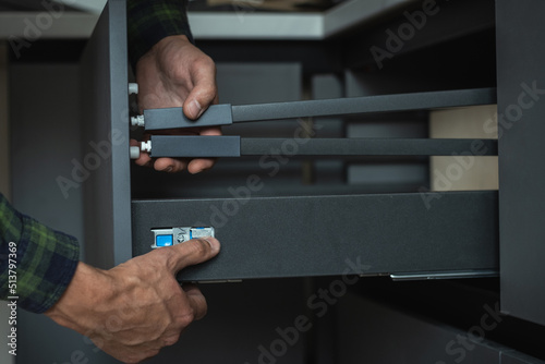 Furniture maker assembling new modern drawer system with adjustment mechanism