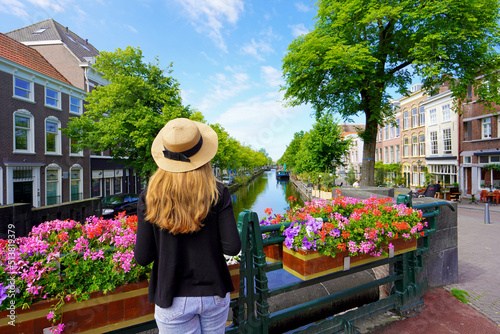 Young tourist woman between flower pots in The Hague, Netherlands