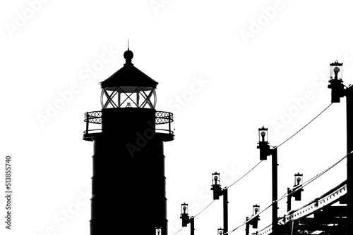 The lighthouse and catwalk in Grand Haven. Michigan, are shown in a black and white silhouette 