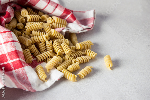 Raw Fusilli inRed Napkin Above Italian Cuisine Ingredient Uncooked Pasta Copy Space