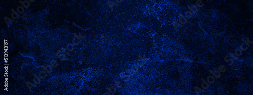 Blue textured paper or concrete wall background. Dark edges. copy space, dark blue rough grainy stone or concrete wall texture background.