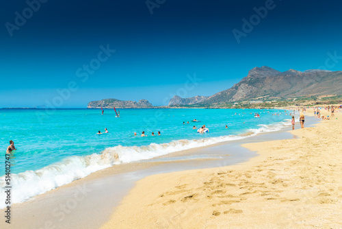 Falassarna, Greece, 13 June 2022: Tourists on the sandy beach of Falassarna in Crete Island