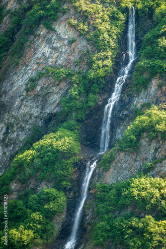 Unnamed waterfall alongside the more famous Bridal Veil Falls down cliffs of Keystone Canyon outside Valdez in Alaska
