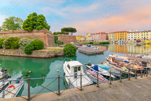Boats line the crowded canals next to the New Fortress at the seafront Tuscan city of Livorno, Italy.