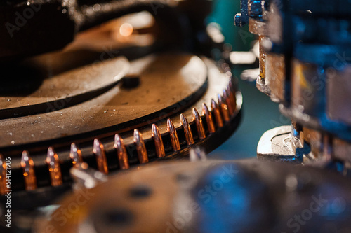 Copper bullets on production line part at weapon factory