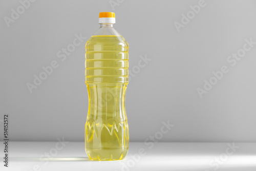 healthy eating, food and culinary concept - close up of cooking rapeseed oil in plastic bottle on table