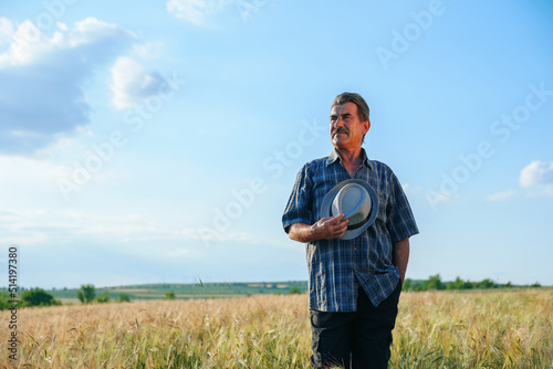 senior male brazilian farmer takes his hat off. the portrait of an elderly man working in the head summer day, agronomist farmer
