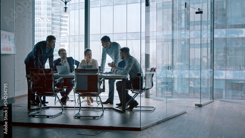 Group of business people working with technology at a meeting in a conference room