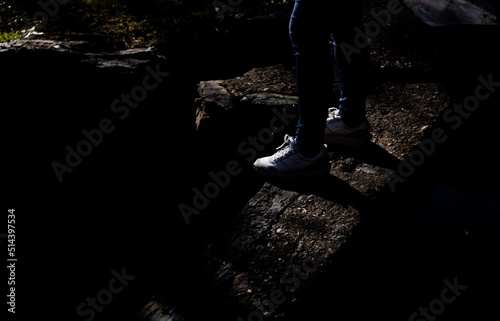 Girl on the edge of cliff in stone.Dark and gloomy mood.