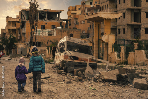 Two homeless little girl walking in destroyed city, soldiers and helicopters and tanks are still attacking the city