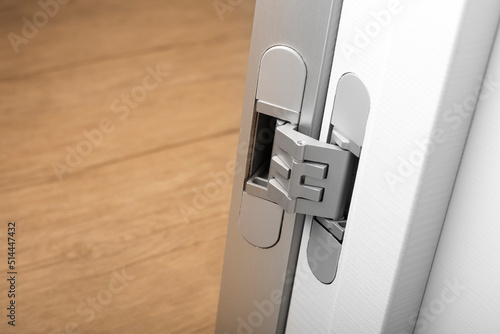 Modern aluminum door hinges on white doors, close-up. copy space, place for text