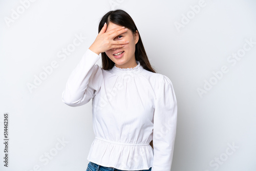 Young Chinese woman isolated on white background covering eyes by hands and smiling