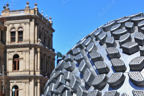 Sphere-shaped aluminium form made with vegetable steamers-Treasury Building background. Brisbane-Australia-010